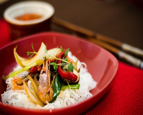 A bowl of unpolished brown rice on a dining setting