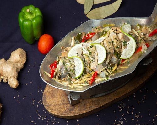 Steamed white fish with lime and ginger layout representing local Thai nutrition